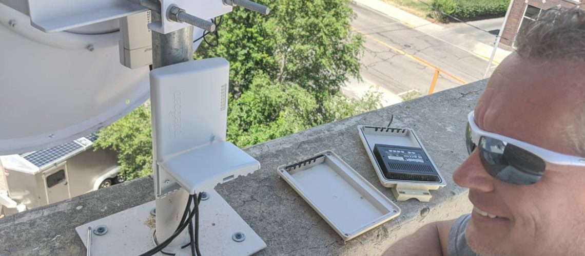 Technician installing wireless internet equipment