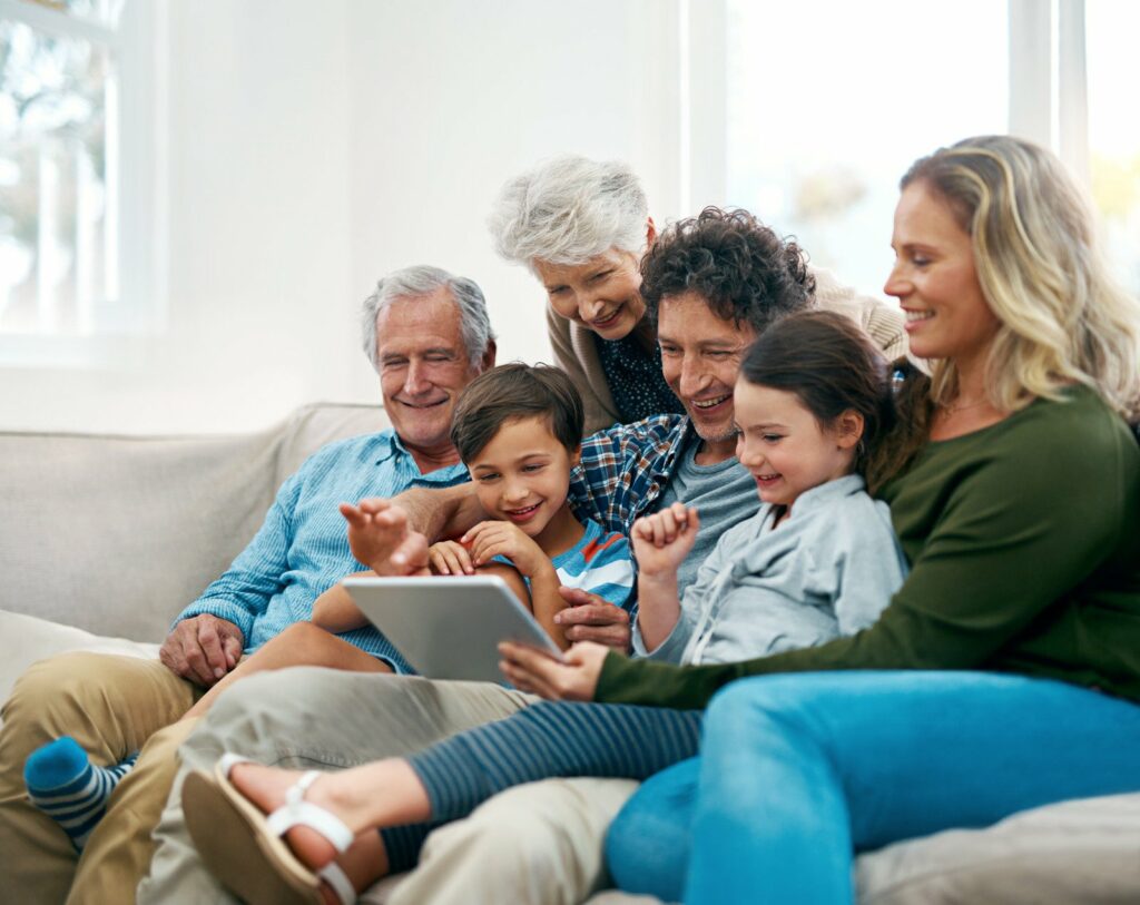 family watching on laptop together on couch